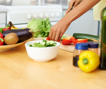 Person preparing healthy food with a knife